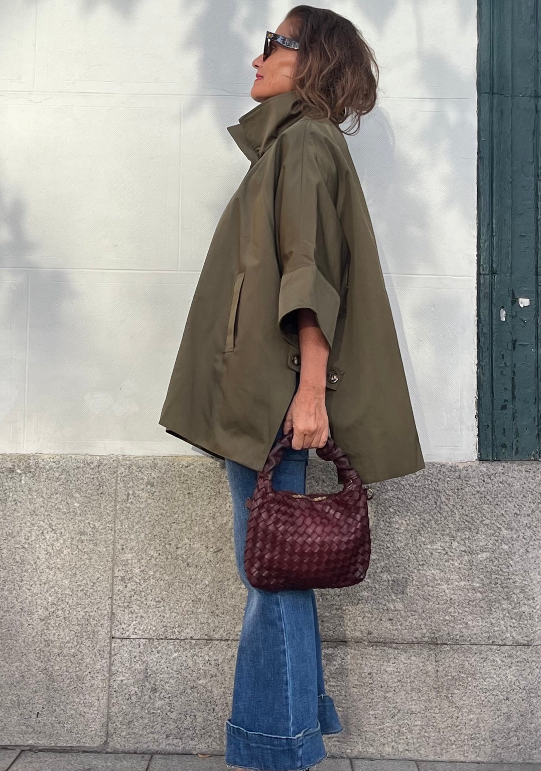 Bolso de piel trenzada burdeos llevado en la mano
