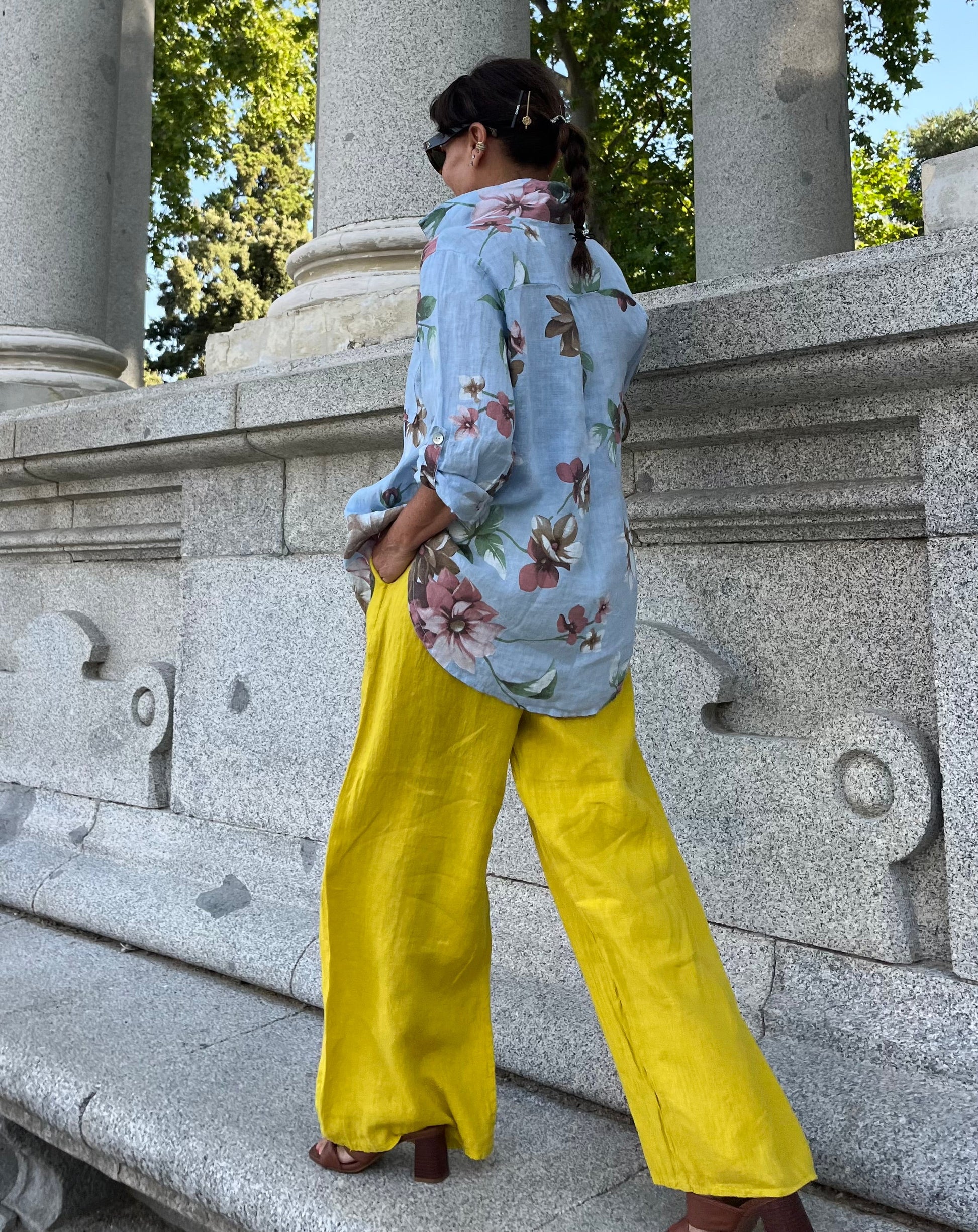 Women’s outfit with a floral shirt and yellow linen trousers by La Canaria